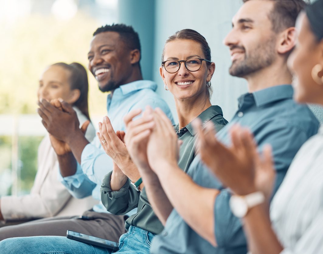 Business audience, hands and clapping in support of speech or presentation during a conference with business people. Business meeting, applause and success with excited colleagues cheering together